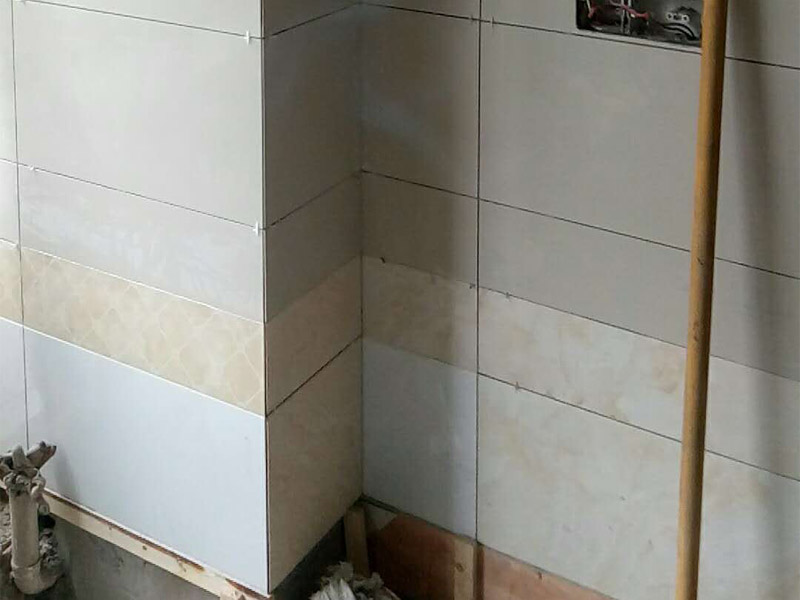 廁所墻面貼磚裝修：1.首先將經(jīng)過預(yù)選的瓷磚背面清理干凈，并浸水2小時以上；2.鋪貼開始前還應(yīng)當(dāng)在墻面找平層上吊垂線，以確定瓷磚的出墻尺寸線；3.鋪瓷磚一般從陽角或門窗邊開始，按由下而上，自左至右的順序進行；4.鋪瓷磚時，應(yīng)及時將瓷磚縫中多余的粘接材料刮理干凈，并用濕棉布擦去面磚上的污跡，千萬不要等到粘接材料干硬后再擦拭清洗，那樣不但不能清洗干凈，如果用硬物刮除又會損害釉面層。