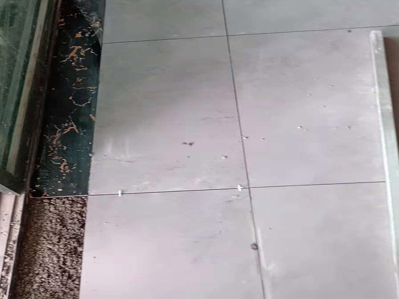 客廳地磚鋪貼：鋪貼的工具包括橡膠錘和粘結(jié)劑。在進(jìn)行施工之前先把所需要的這些材料都整理好放在一旁備用；基層的處理工作對瓷磚的平整度有很大的影響，對于基層要做好清潔工作，還有找平工作。放樣：在進(jìn)行瓷磚的鋪貼工作之前還事先找好垂直線，這樣可以在鋪貼的時(shí)候找到瓷磚的水平線，讓瓷磚鋪貼的更加的平整。粘結(jié)劑加水?dāng)嚢杈鶆?，靜置10分鐘之后就可以使用。將瓷磚表面的浮灰清除，再在瓷磚背面均勻的涂抹上粘結(jié)劑，按照預(yù)鋪的順序?qū)⒋纱u鋪貼在地面上，最后用橡膠錘輕輕拍打至服帖齊整。