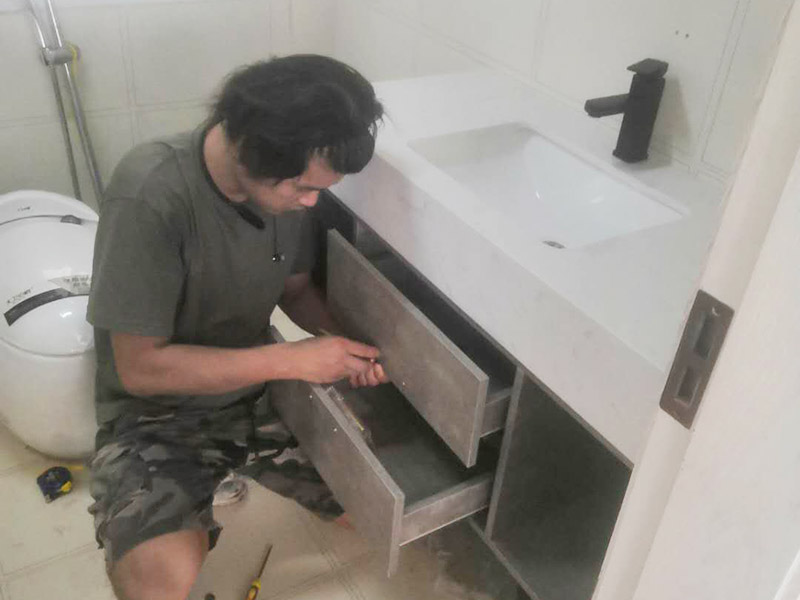 浴室柜及燈具安裝：安裝前，檢查零配件是否齊全。安裝三角閥，確保冷熱進水管保持齊平。測量距離，安裝下水管。涂抹膠水要均勻，確保管與管間連接緊密。安裝柜角，看所有角是否在同一水平。裝好后可做適當?shù)恼{(diào)整。將浴室柜靠墻放好?？催M出水管位置是否得當，不合適時需做一定改動。安裝臺盆的龍頭。龍頭最好與浴室柜配套購買，這樣出水角度較為適合。用螺母固定臺盆龍頭。固定時一只手要扶好龍頭，以免裝好后位置偏離。將裝好龍頭的臺盆放在浴室柜上，調(diào)整位置到最佳為止。連接臺盆的進出水管及下水，長度適當，位置合理。裝好柜體的把手，并進行適