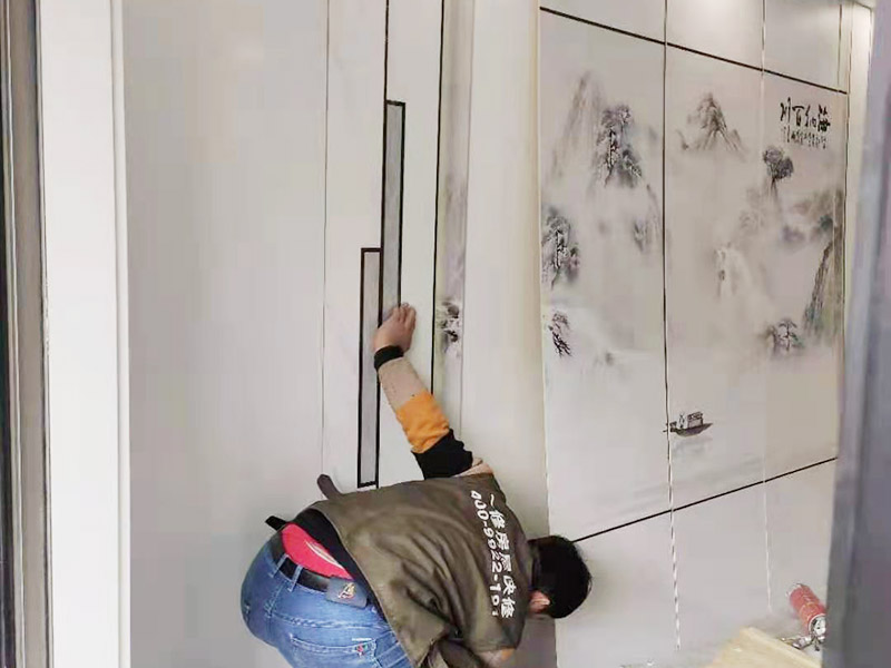 客廳背景墻安裝：在安裝護(hù)墻板前，首先對(duì)背景墻除塵和找平處理，以保證基層光滑平整且無(wú)顆粒等臟物。以確保墻板安裝時(shí)的平穩(wěn)度和牢固度。開始根據(jù)電視背景墻的尺寸切割墻板，若護(hù)墻板需做整面墻，切割時(shí)一定要注意長(zhǎng)寬尺寸的精確度，切記偏差不可過大。開始安裝，順序是由下至上，由左至右，并距離板塊上端1.5CM左右，用膨脹螺絲將其固定住，同時(shí)注意不要露出護(hù)墻板表面，否則影響美觀度。將墻板全部安裝好后，直接使用專用膠來(lái)固定便可。 在安裝過程中要注意墻板紋飾顏色是否一致，保持分隔線一致、順暢，不可錯(cuò)亂，否則會(huì)拉低整個(gè)電視背景墻的美觀度。安裝好后對(duì)拉縫處安裝壓條，增強(qiáng)裝飾效果。